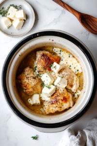 This image shows cream cheese pieces distributed over the chicken