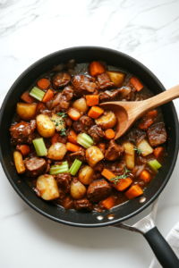 This image shows sautéed vegetables being carefully transferred from a skillet to a saucepan, preparing them for the addition of beans and broth.