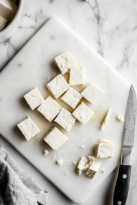 This image depicts tofu strips with corners being trimmed for a more rounded, authentic chicken tender shape, adding an aesthetic touch.