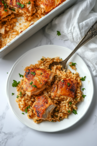 This image shows a spoon lifting a cheesy portion of chicken and rice casserole from the dish, revealing the creamy layers inside.