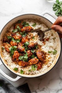 This image shows the biryani being sealed with a tight lid, trapping in the steam for a slow ‘dum’ cooking process. Garnished with cilantro, mint, and crispy onions, the flavors meld together beautifully.