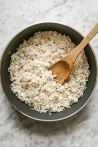 The rice is being gently toasted in the olive oil, enhancing its flavor and giving it a slight golden hue before adding liquid.