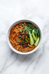 pouring-teriyaki-sauce-to-coat-noodles-and-veggies-evenly
