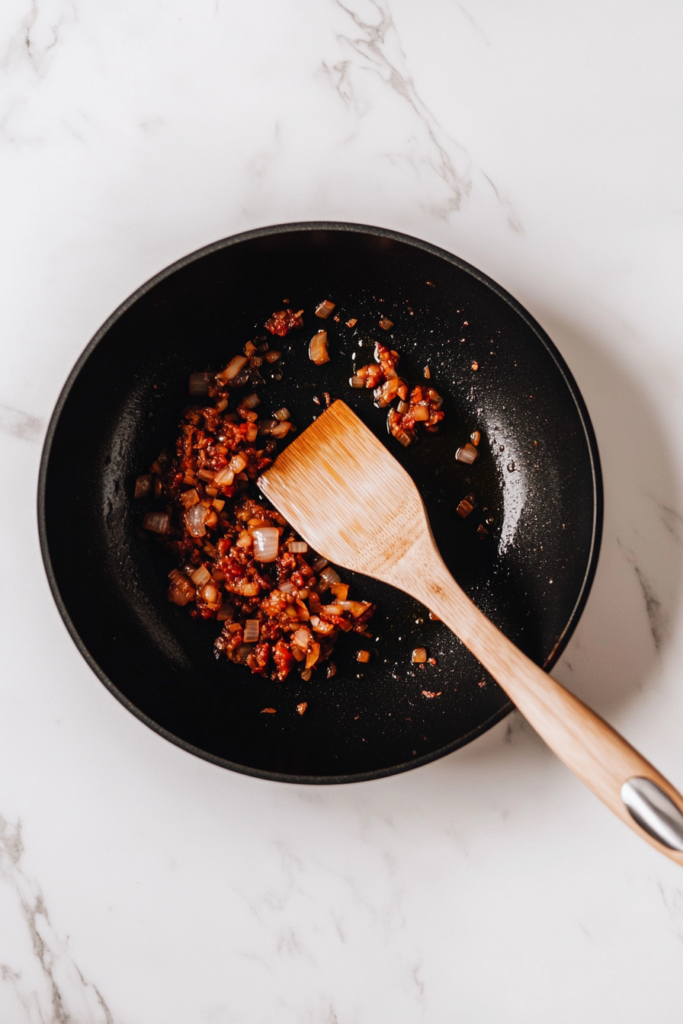 sauteing-onions-in-a-pan-to-create-a-flavorful-base-for-bang-bang-chicken-and-shrimp-1313790-683x1024