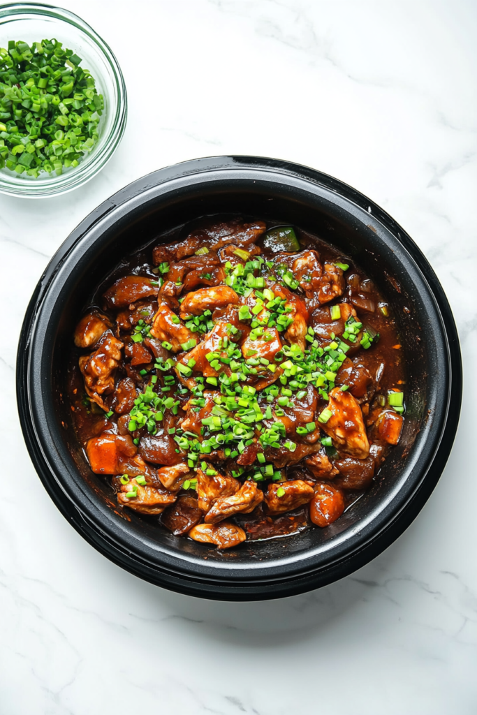sprinkling-fresh-green-onions-over-chicken-and-vegetables-stir-fry-for-garnish-5291037-683x1024