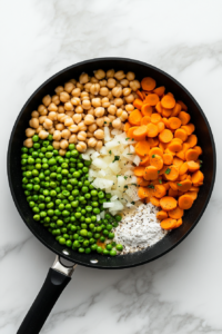 adding-chickpeas-and-liquid-to-veggie-mixture
