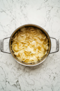 caramelizing-onions-in-aluminum-pot-on-white-marble