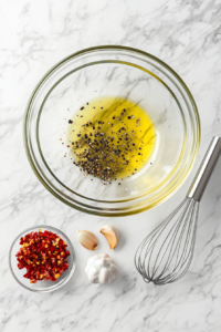 herb-marinated-oil-mixture-in-glass-bowl-on-white-marble